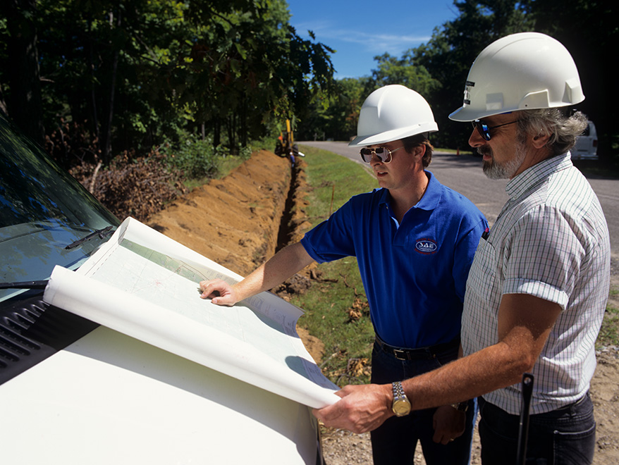 SAE employees looking at Map | SAE Inc.