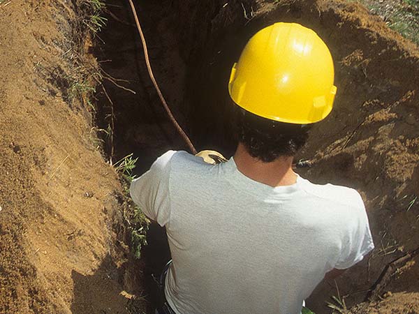 man laying electrical line